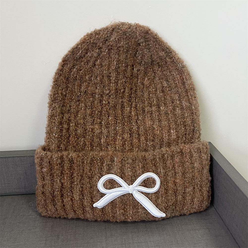 Hat women's autumn and winter wool hat new cute bow versatile cold hat ear protection warm knitted hat tide