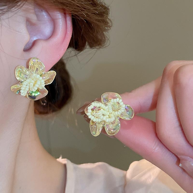 Woven rice bead flower stud earrings are small, exquisite, fashionable, simple wind earrings, niche sweet wind earrings.