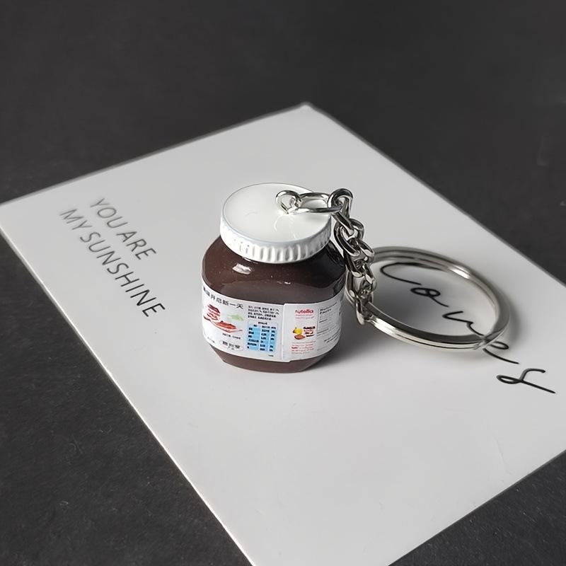 2 Stück Kreative Simulation Haselnuss Schokolade Marmeladenglas Flasche Schlüsselanhänger Paar Schlüsselanhänger Taschenanhänger Auto Schlüsselhalter Geschenke