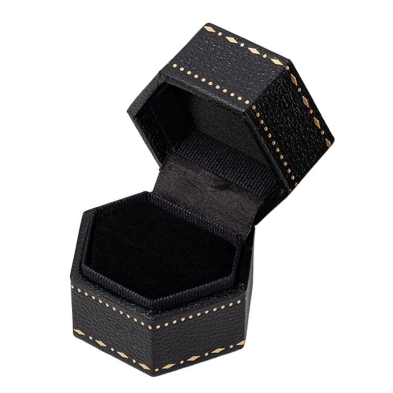 Hexagonal Ring Presentation Box with Black Interior, Gold-Tone Border Pattern, and Attached Lid for Retail Display