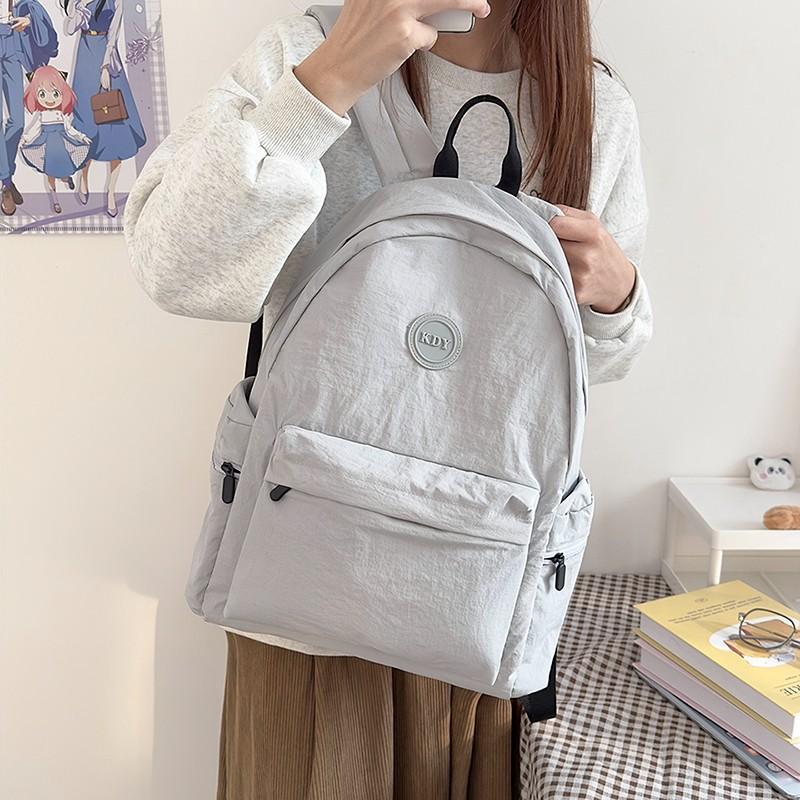 New schoolbag fashionable commuter versatile backpack Japanese simple solid color junior high school students college style backpack 28*13*43