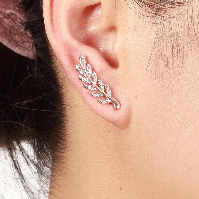 European Fashion Silver Needle Leaf Stud Earrings with Symmetrical Hollow Design and Modern Elegance