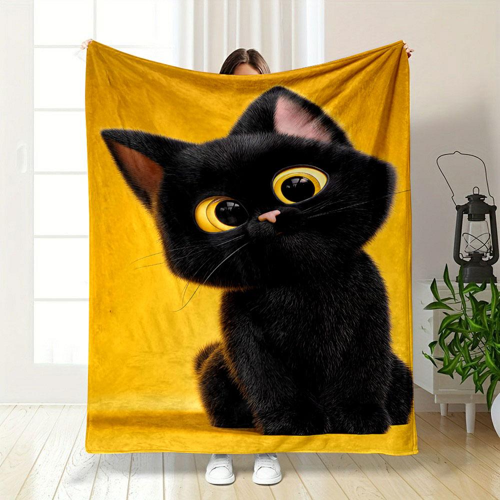 A black kitten with large yellow eyes sits against a bright yellow background. for all seasons blanket lunch break throw gift