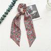Long flowing ribbon large braided hair accessory for women - ponytail bun hair band with floral design, simple and elegant.
