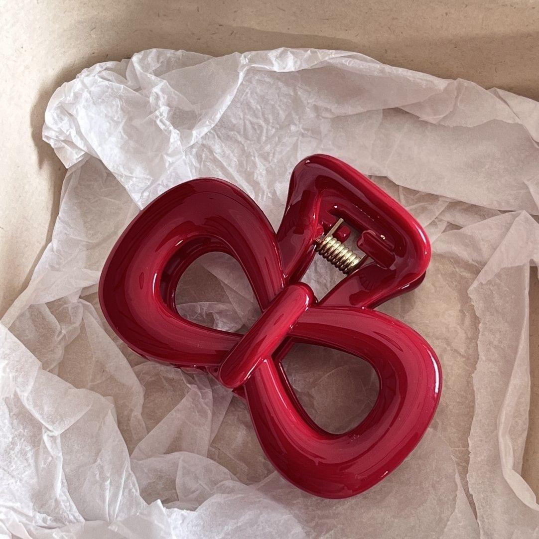 

Жіноча ретро синя шпилька в горошок з червоним бантом