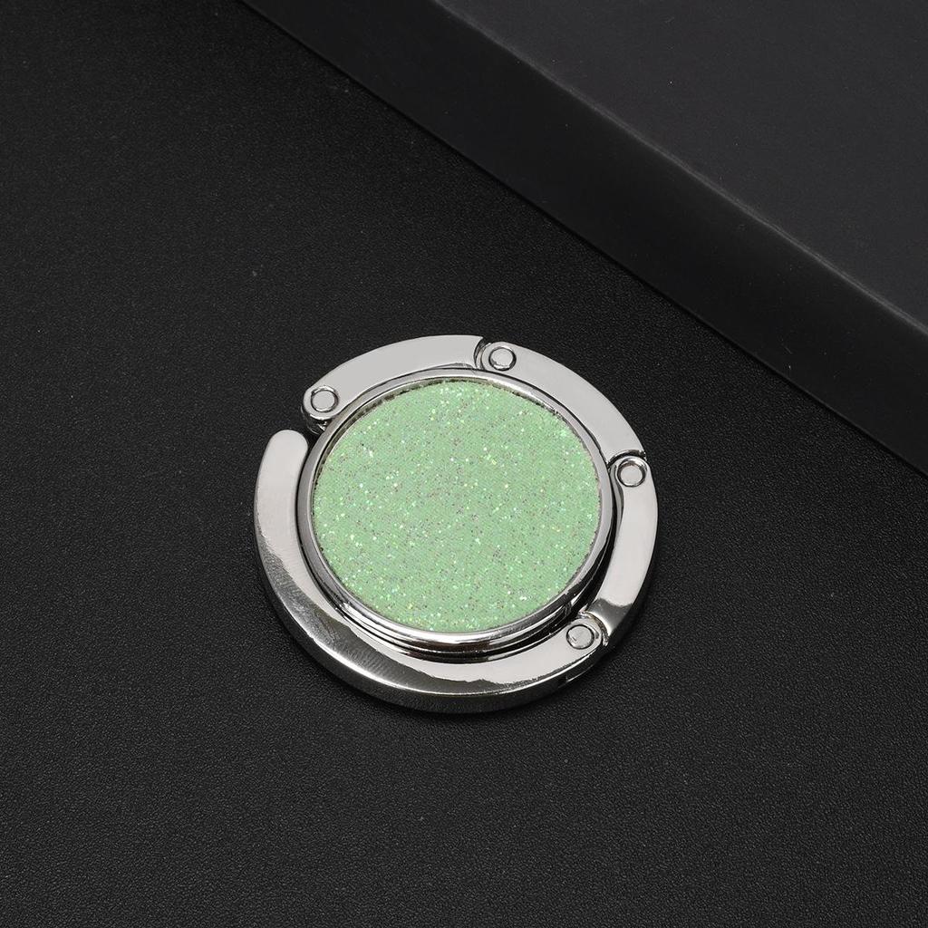 Kulatý skládací háček na kabelku – Přenosný kreativní věšák na batoh na okraj stolu.