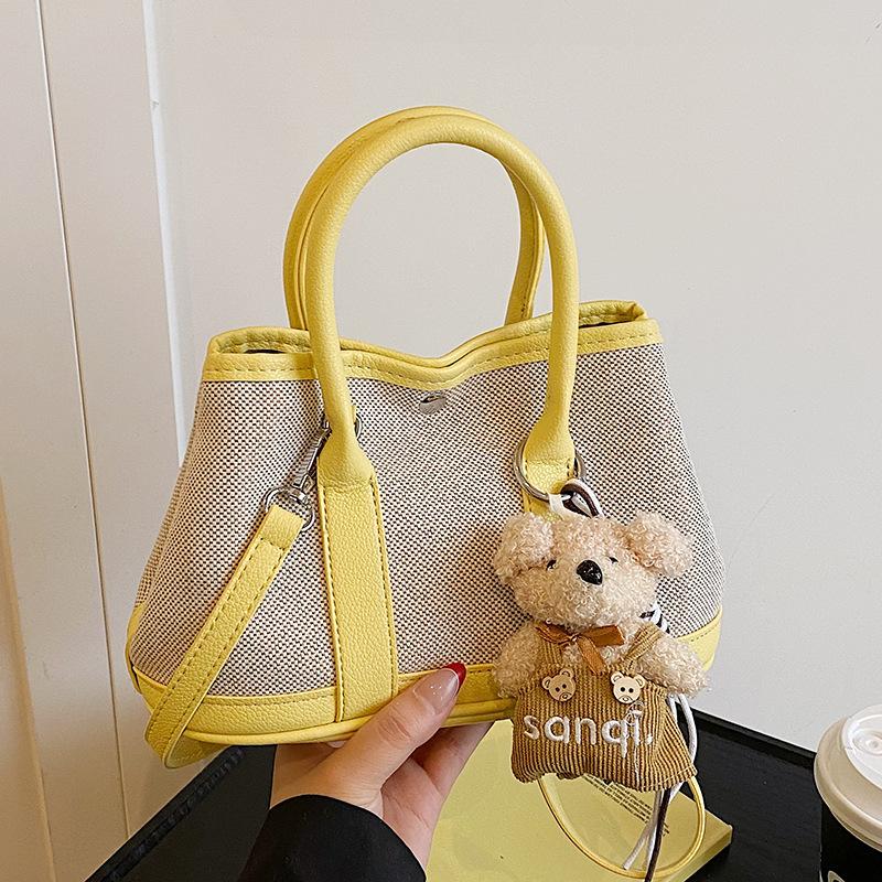 Korean version of casual niche contrasting color splicing portable bucket bag fashion versatile temperament casual commuter messenger bag woman