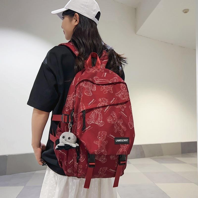 24 New cartoon printed large-capacity junior high school students' male and female school bags, fashionable casual backpacks