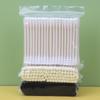 Pack of 100 double-ended, disposable cotton swabs with paper sticks for ear cleaning and makeup application.