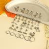 Stainless steel piercing ear bone stud earrings with star and moon designs.