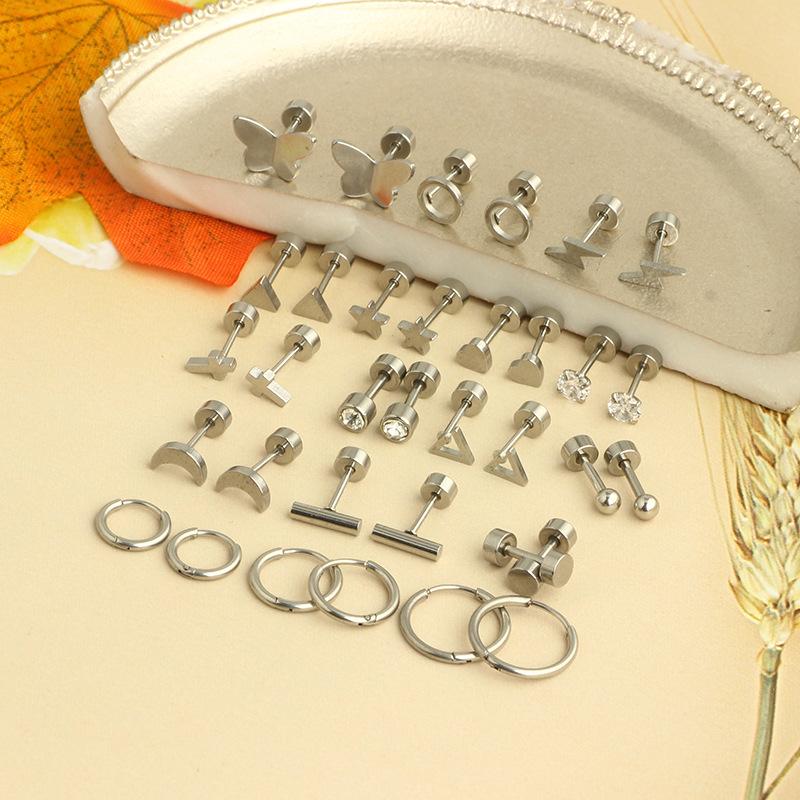 Stainless steel piercing ear bone stud earrings with star and moon designs.