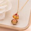 Enamel Egg Pendant Necklace with Hinged Opening, Collarbone Chain, Gold-Tone Chain, and Easter Outfit Styling for Women