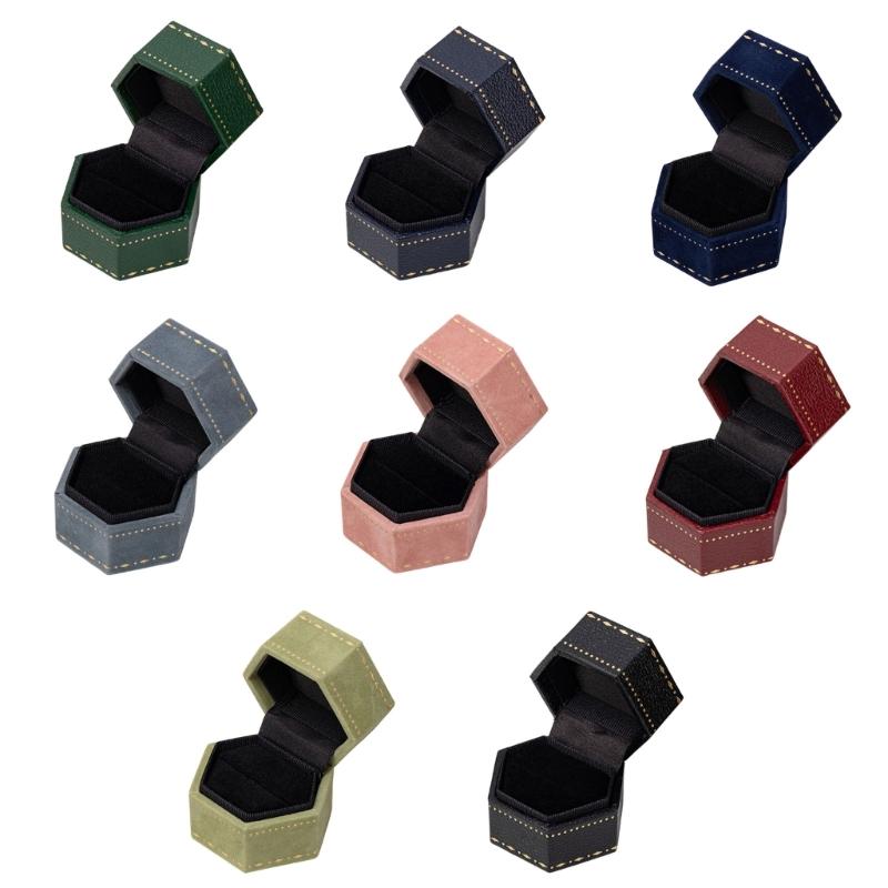 Hexagonal Ring Presentation Box with Black Interior, Gold-Tone Border Pattern, and Attached Lid for Retail Display
