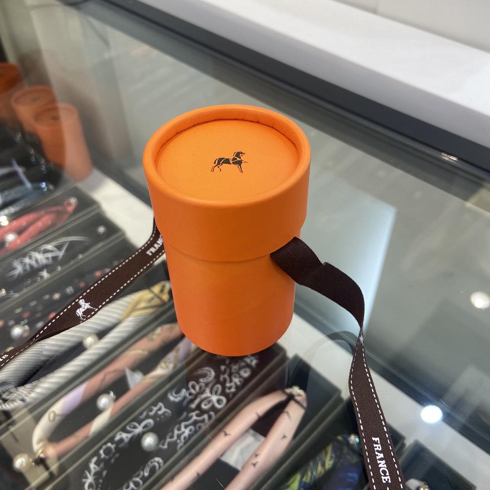 Exquisitely Decorated Orange Round Gift Box with Ribbon Neckerchief