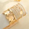 Elegante Vintage Hohllinien-Streifenblumen-Drehmetall-Armreif-Armband-Sets für Damen Tägliches Tragen Party Hochzeit Urlaub Schmuck