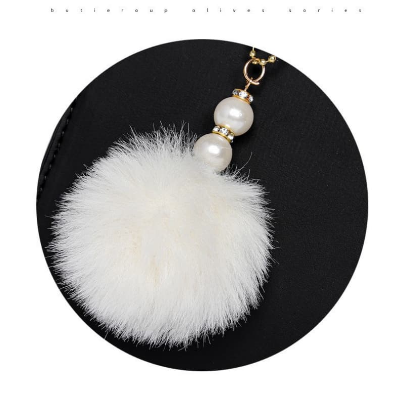 Bolsa pequena transversal decorada com bola de pelo, elegante