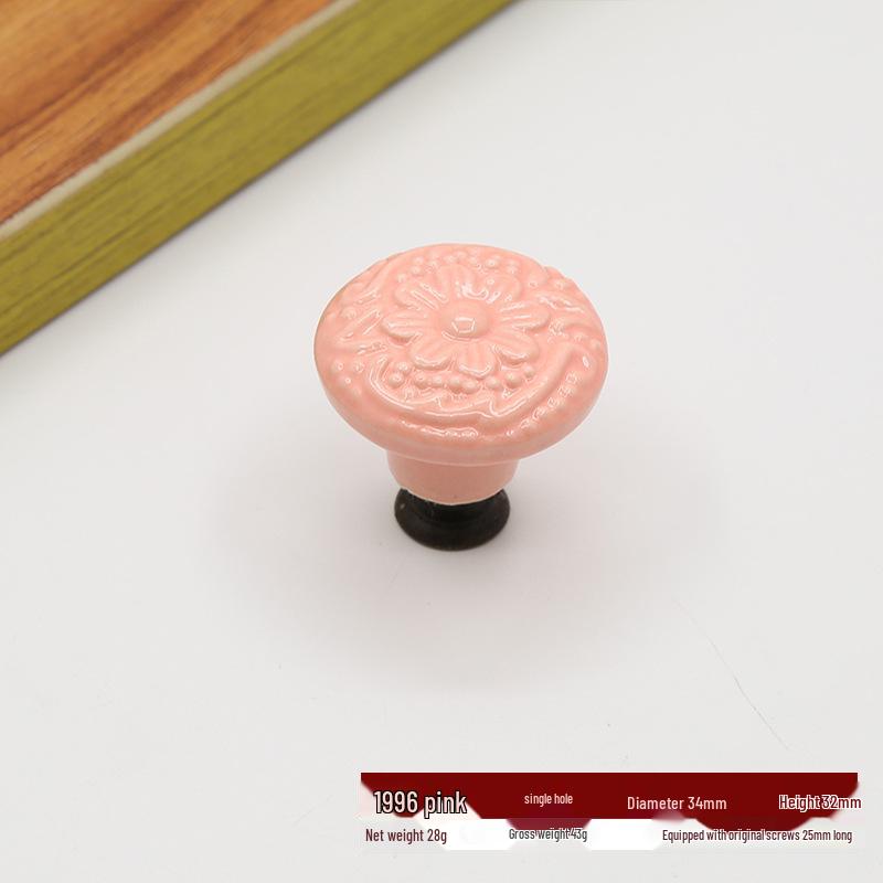 Antikt vit keramiskt lådhandtag med präglad blomdesign