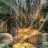 2D Lush Green Waterfall with Stone Wall Background for Photoshoot