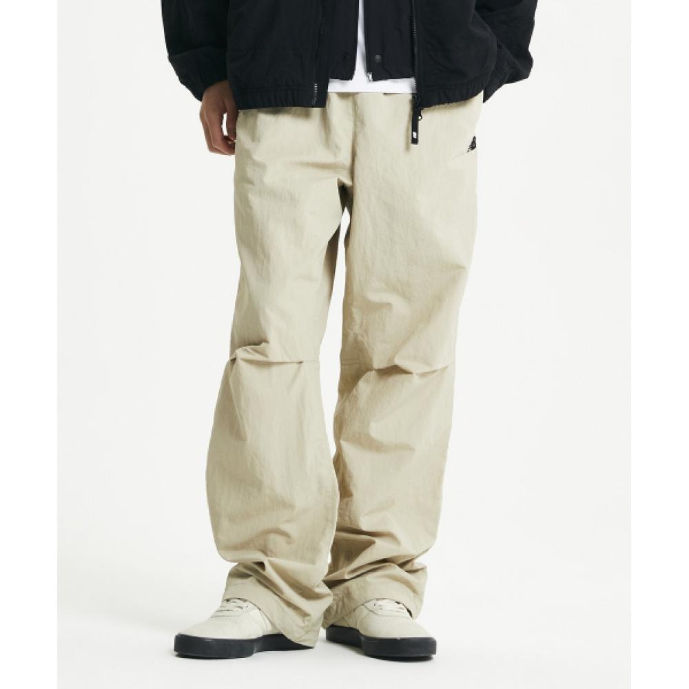 

NEW BALANCE NBNTE11013 ПРЯМЫЕ БРЮКИ UNI ESS HERITAGE ТКАНЫЕ БЕЖЕВЫЕ