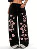 Women's black and pink jogging pants with a cherry blossom print inspired by Japanese floral designs