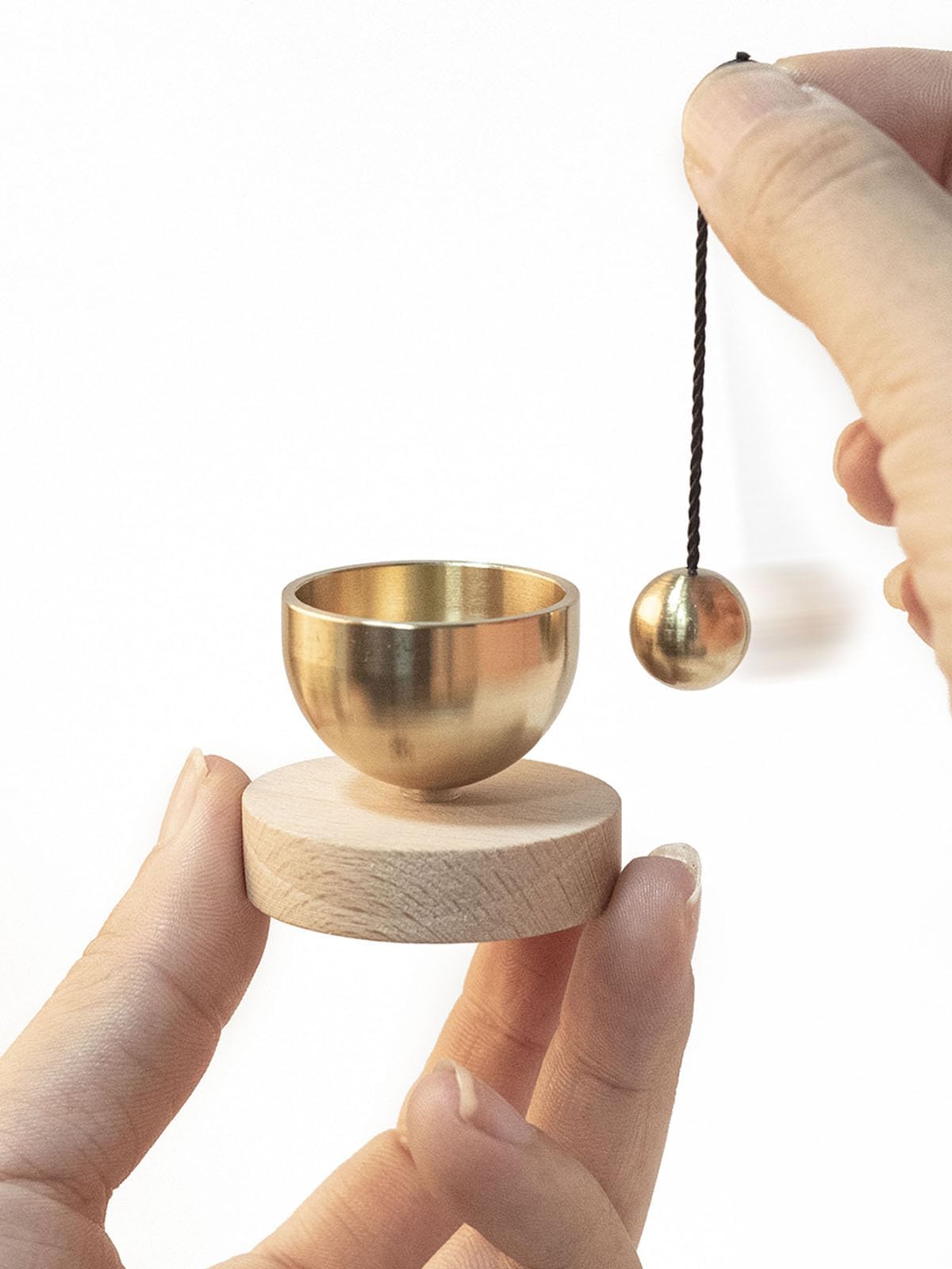 

This modern Buddhist altar bell set features beautifully tuned sounds and is crafted from brass and natural wood. Perfect for family, dogs, cats, and
