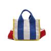 2025 fashion new women's bag niche design color matching canvas bag foreign style portable magnetic buckle bag versatile shoulder bag tide