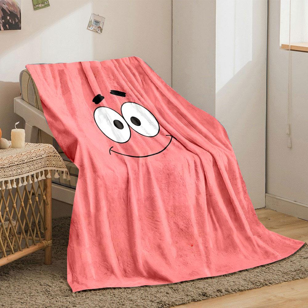 A simple pink background with a smiling cartoon face and wide eyes. for all seasons blanket lunch break throw gift