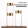 65mm Thickened High-Transparency Glass Bottle with Gold Oxidized Aluminum Screw Cap for Cereal and Grain Packaging.
