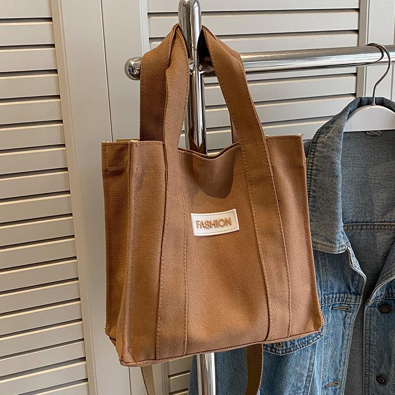 

Niche canvas bag 2025 new fashion out portable women s small square bag Korean version versatile shoulder messenger bag коричневый