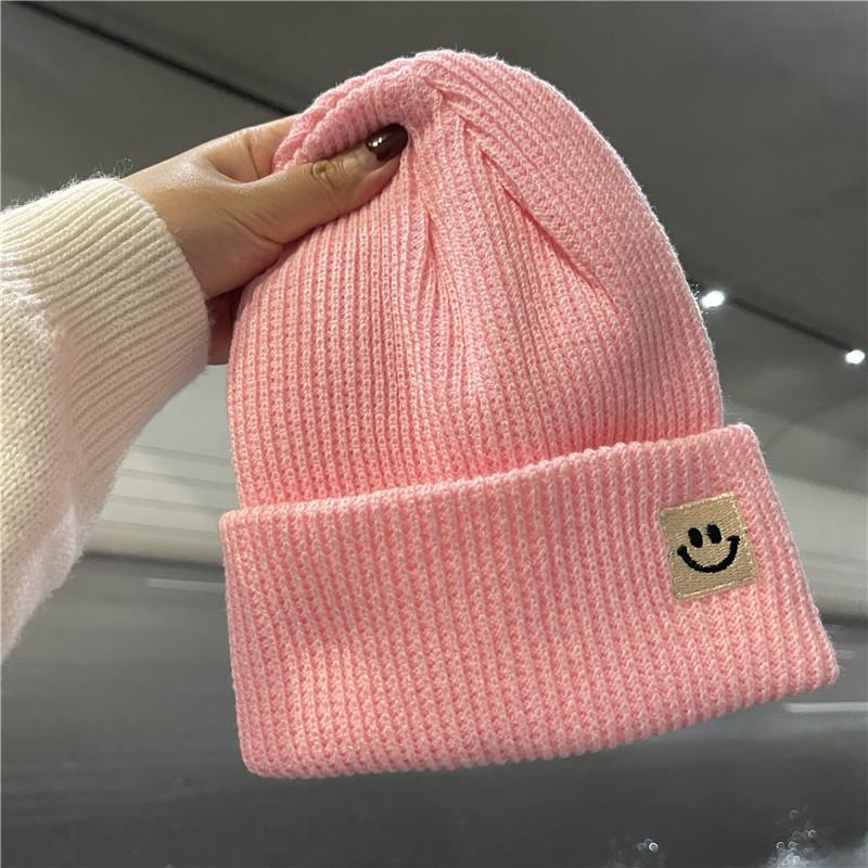 Cute smiley face label wool hat women's autumn and winter warm trend versatile ear protector black knitted hat men