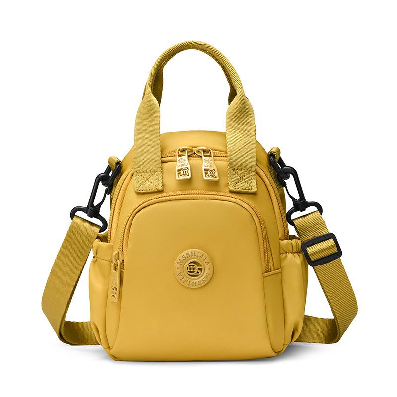 Kompakt Nylon Crossbody Miniryggsäck med Topphandtag Casual Liten Dagryggsäcksväska för Kvinnor Daglig Resa