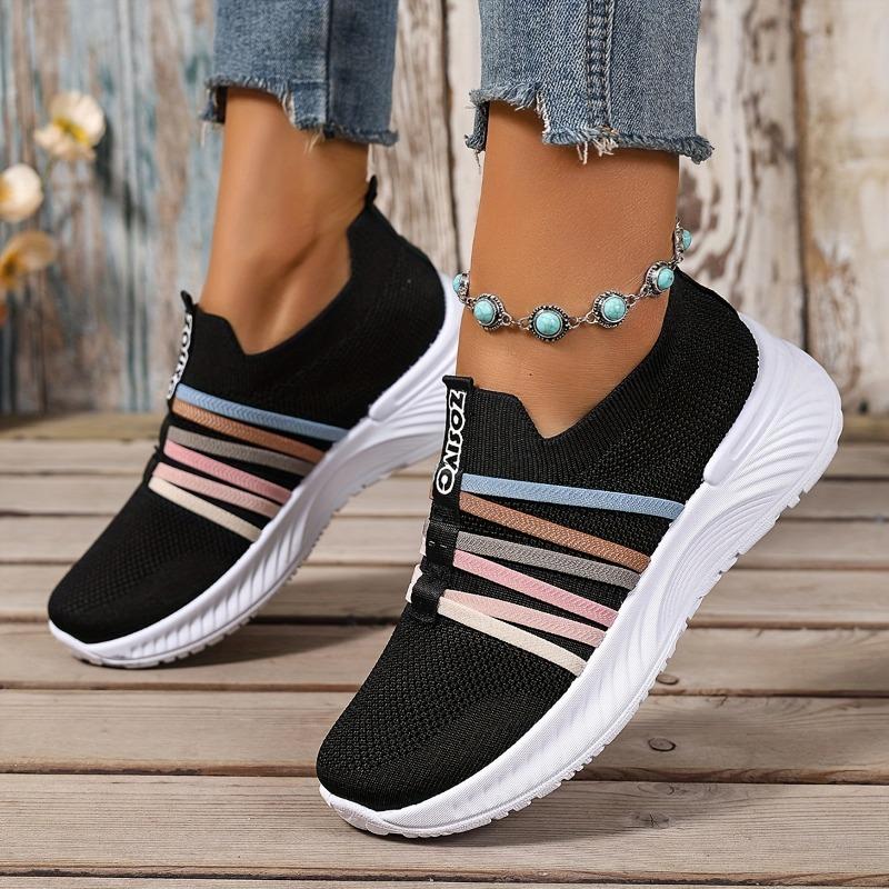 The Lady Wears Slip-On Casual Sports Shoes, Featuring a Breathable Mesh Design with Pastel Stripes, Suitable for Tennis And Comfortable