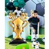 Football and trophy shaped self-standing foil party balloon set, including balloon base.