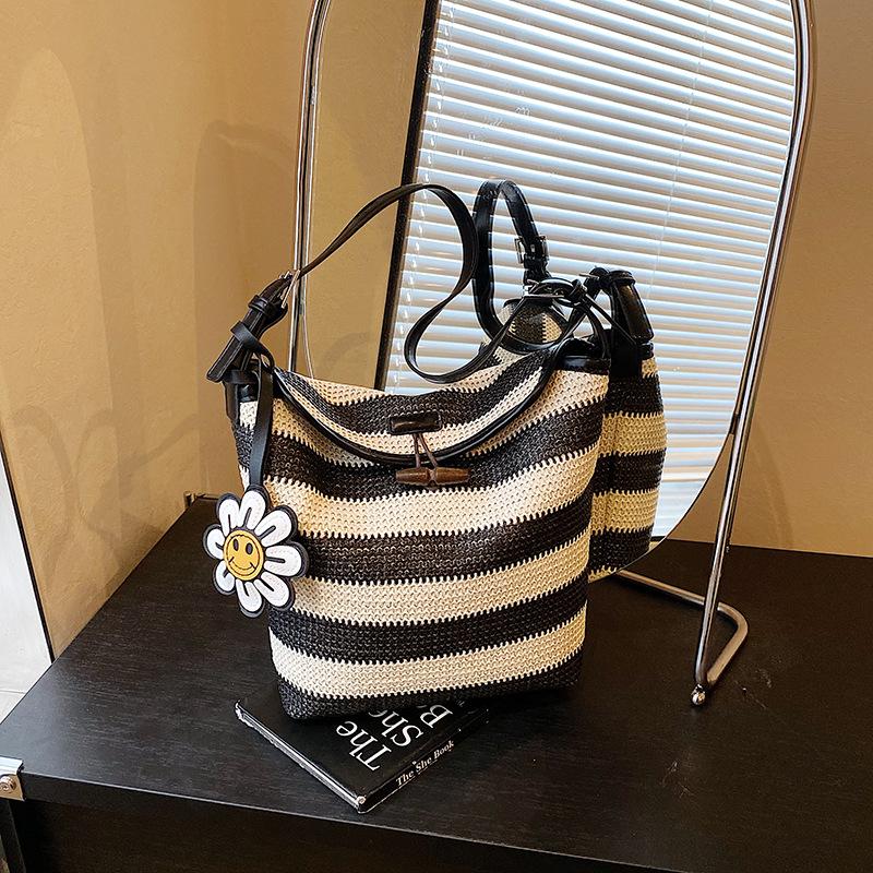 Design sense bag women's summer contrasting color striped woven bag large capacity leisure vacation bucket bag