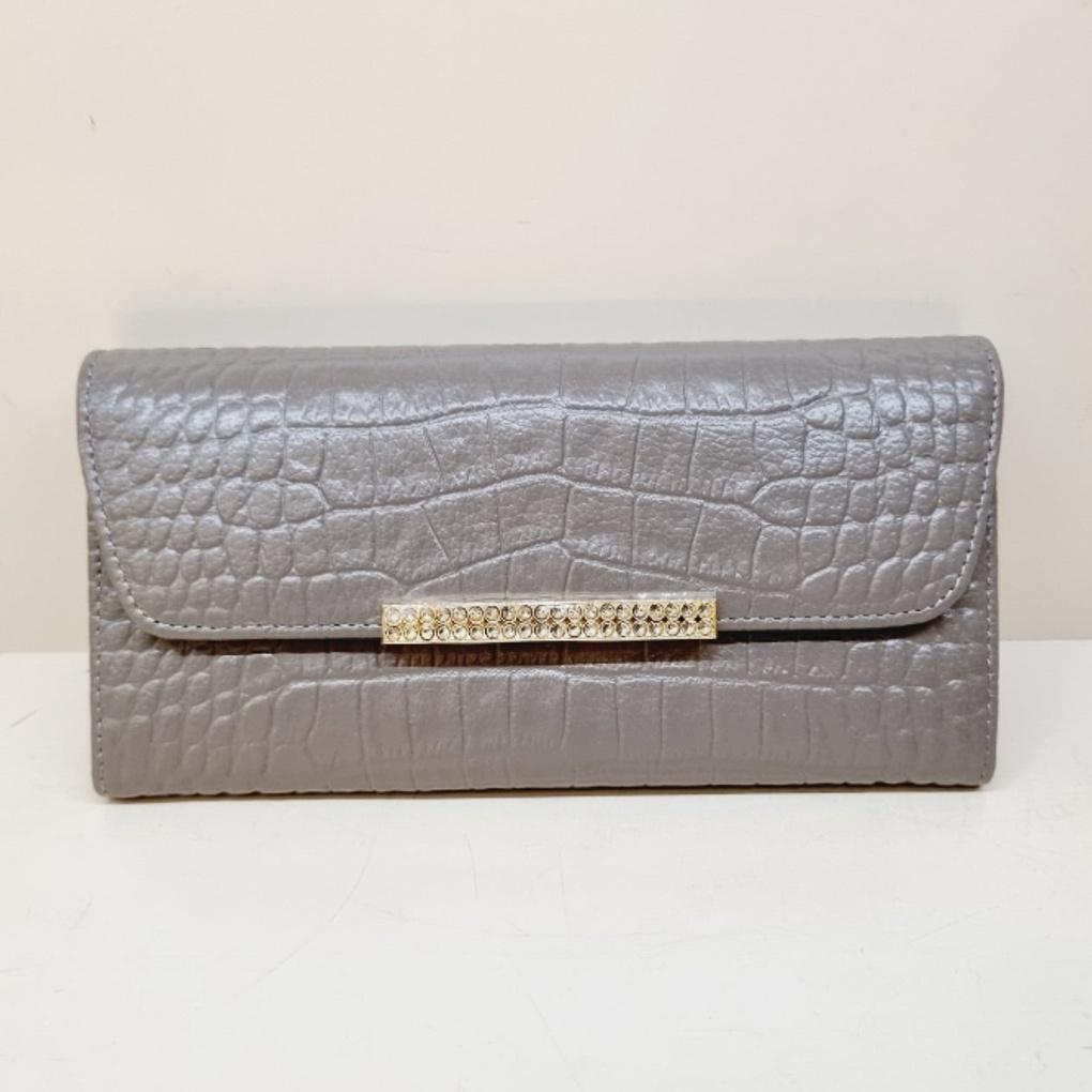 A soft, slim women's long wallet with a subtle pattern.