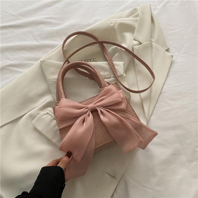 

Silk scarf bow decorative bag women s handbag 2025 summer summer new temperament gentle shoulder messenger bag рожевий
