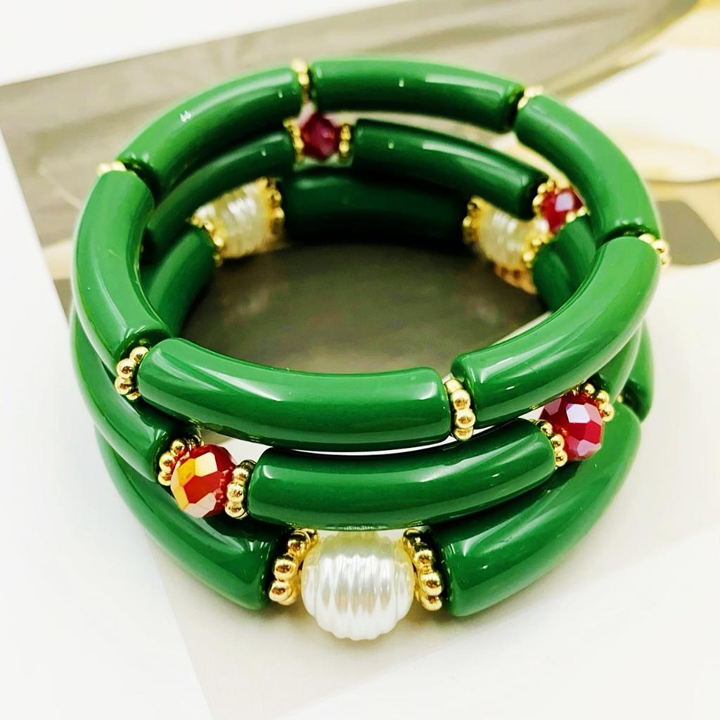 A set of three acrylic tubes connected by small golden flowers, adorned with crystal and faux pearl decorations, suitable for a lady's party.