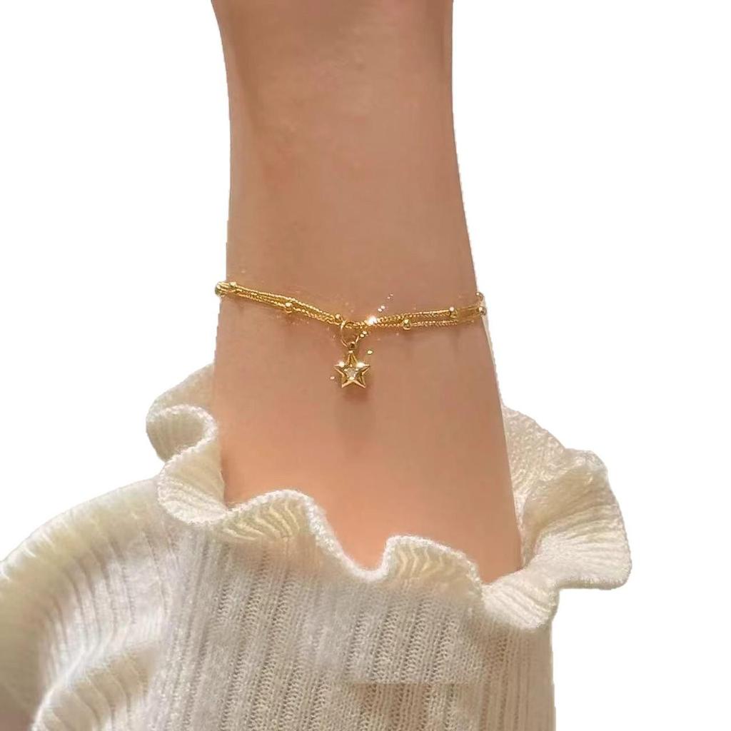 Gold Double-Layer Star Pendant Bracelet for Women - Small Wrist Design, Unique & Elegant.