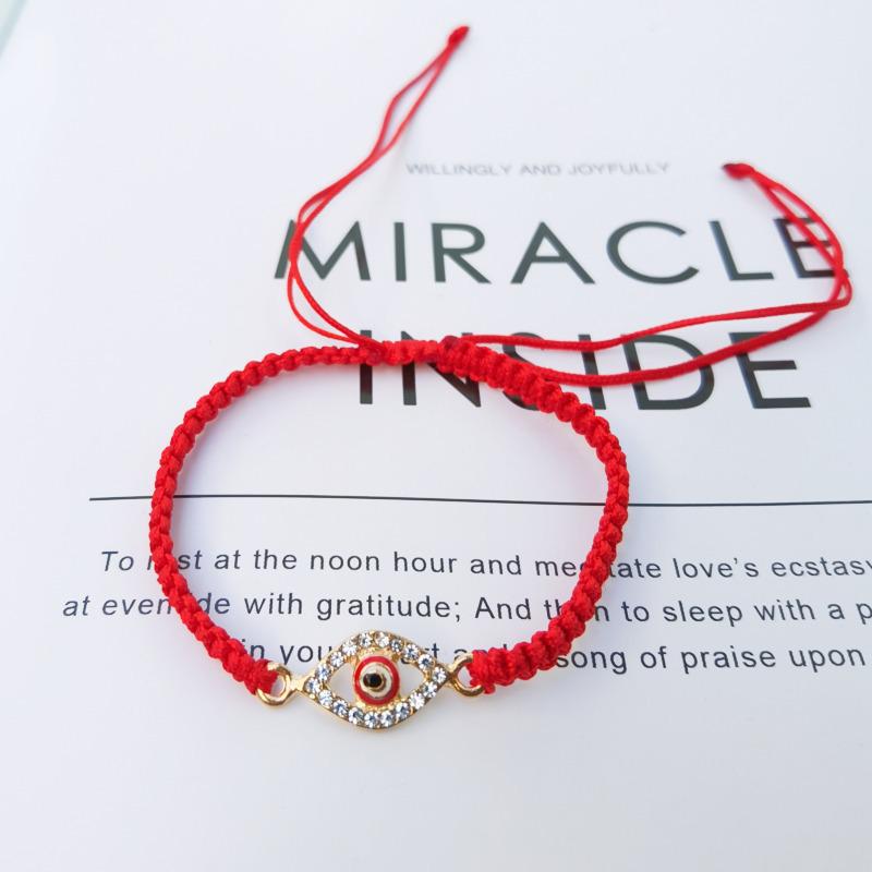 

Браслет ручной работы из плетеного шнура с глазами из страз, нитью из нефрита и узлом «Кинг-Конг»