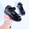 A pair of 2025 new bow student children's leather shoes exported to Africa black PU school shoes factory wholesale