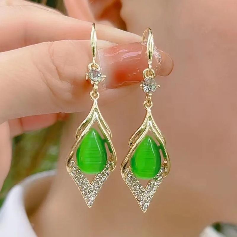 Light luxury hollow diamond cat eye earrings for women alloy inlaid droplet long earrings slim face retro versatile elegant jewelry