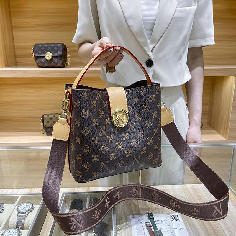 

Niche design new women s bag versatile printing contrasting color handbag retro letter wide shoulder strap bucket bag messenger bag