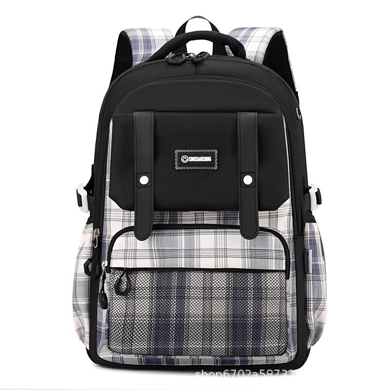 New schoolbag for primary school students, plaid load-reducing ridge backpack, anti-splashing water and wear-resistant canvas backpack, fashionable.