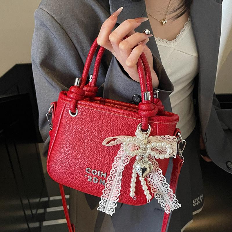 This year, the popular lychee pattern is simple and high-end, portable bucket bag, women's commuting versatile casual style messenger bag