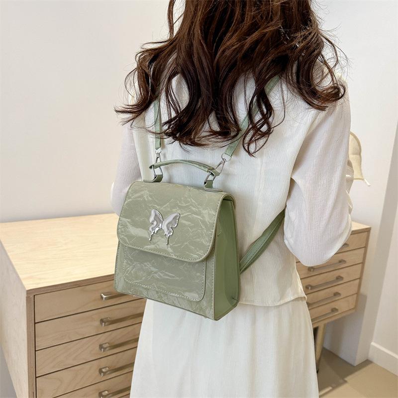 Design Solid Color New Fashion Casual Butterfly Hardware College Wind Backpack Shoulder Backpack Women