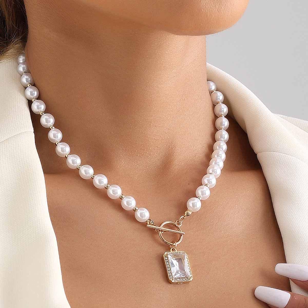 A Versatile And Sophisticated Faux Pearl Necklace With An OT Clasp, Featuring A Rectangular Beaded Faux Diamond Pendant.