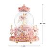 Snow globe music box with colored LED lights, merry-go-round, crystal ball, and automatic snowfall. Popular as a birthday or Christmas gift for girls,