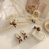 Pearl love bow hairpin rice bead weaving beige series grab clip literary light luxury hair accessories