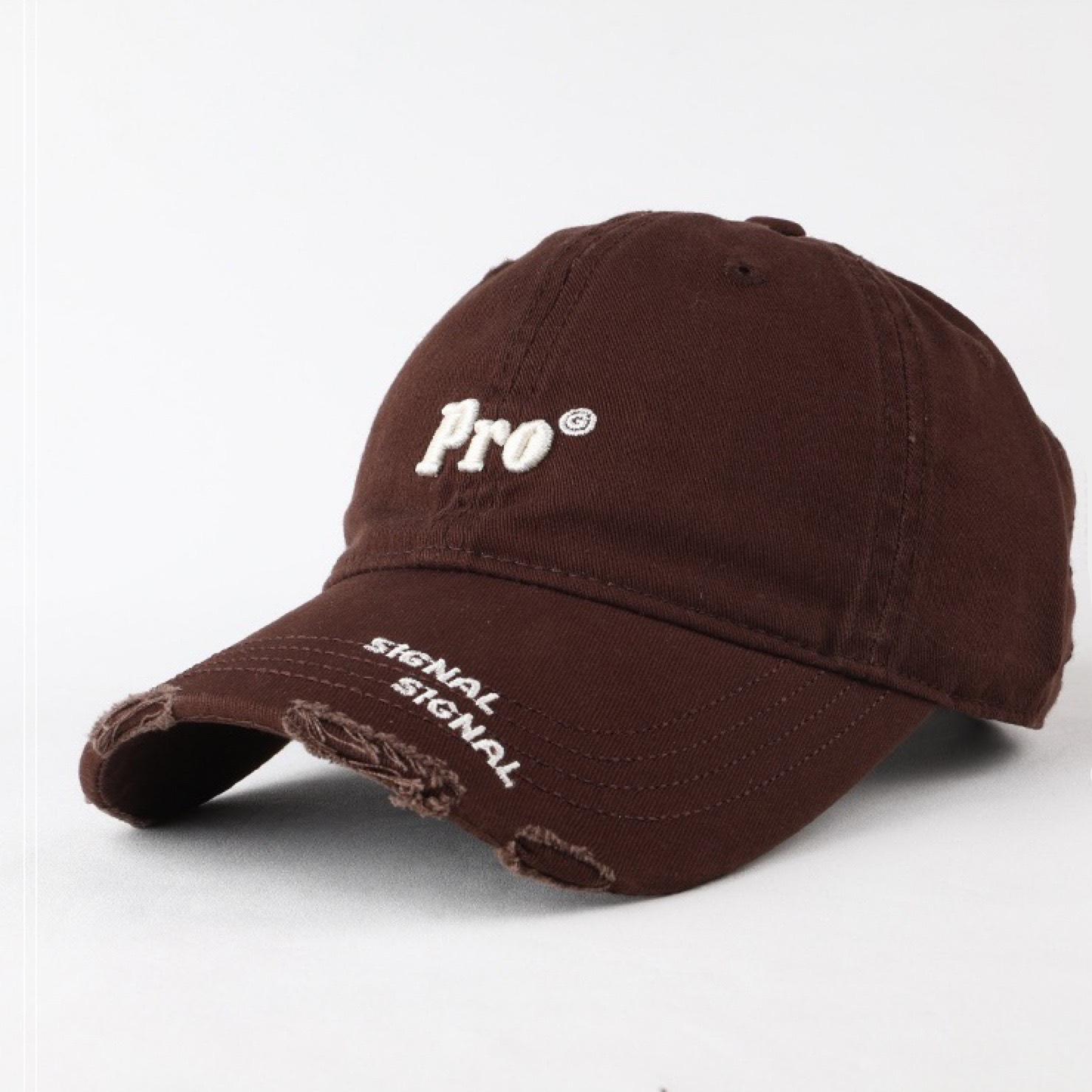 

A Simple Korean Style Baseball Cap with A Small Embroidered Face Featuring A Perforated and Curved Brim
