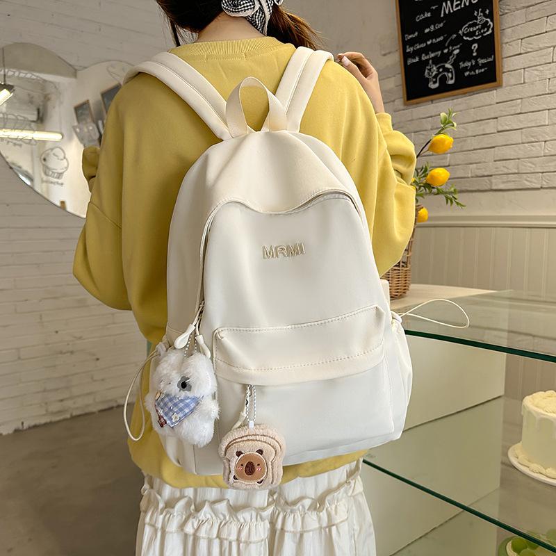Cream school bag for female junior high school students, high-value niche computer travel backpack, simple and versatile college student backpack